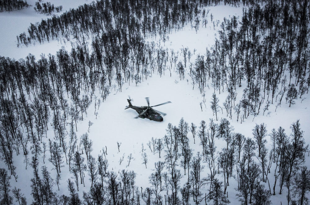 A Royal Navy Merlin Helicopter from the Commando Helicopter Force lands in a clearing in Norway
