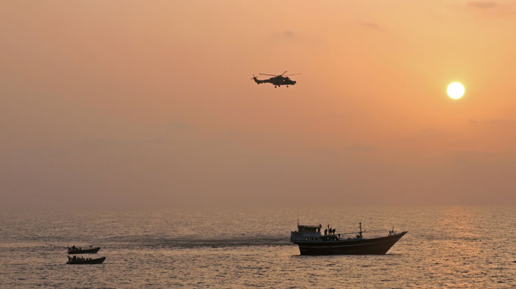 HMS Montrose Wildcat helicopter and Sea Boats strike at the dhow at dawn