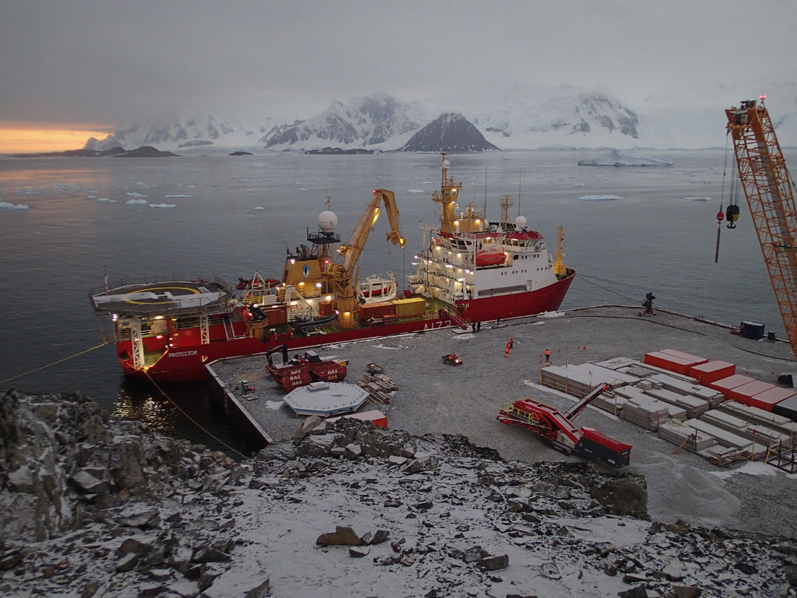 HMS Protector offloads supplies at dusk at Rothera Research Station