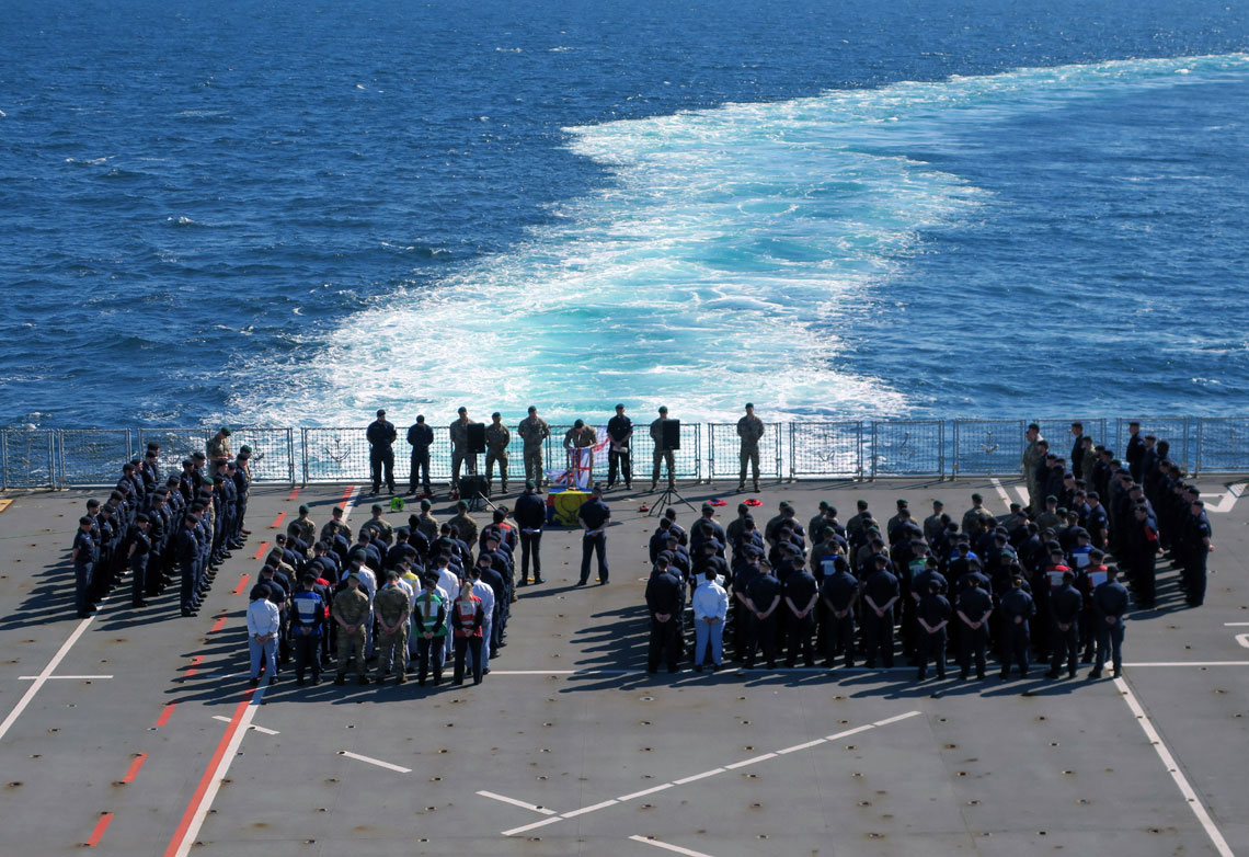 HMS Albion's sailors and marines attend the service on the flight deck