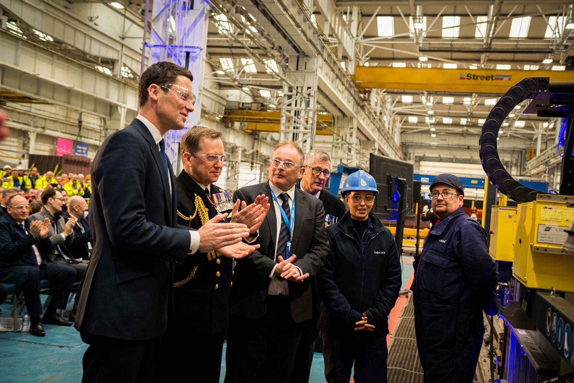 Defence Minister Alex Chalk, Second Sea Lord Vice Admiral Martin Connell and Active veteran Mark Davis watch the steel cut begin