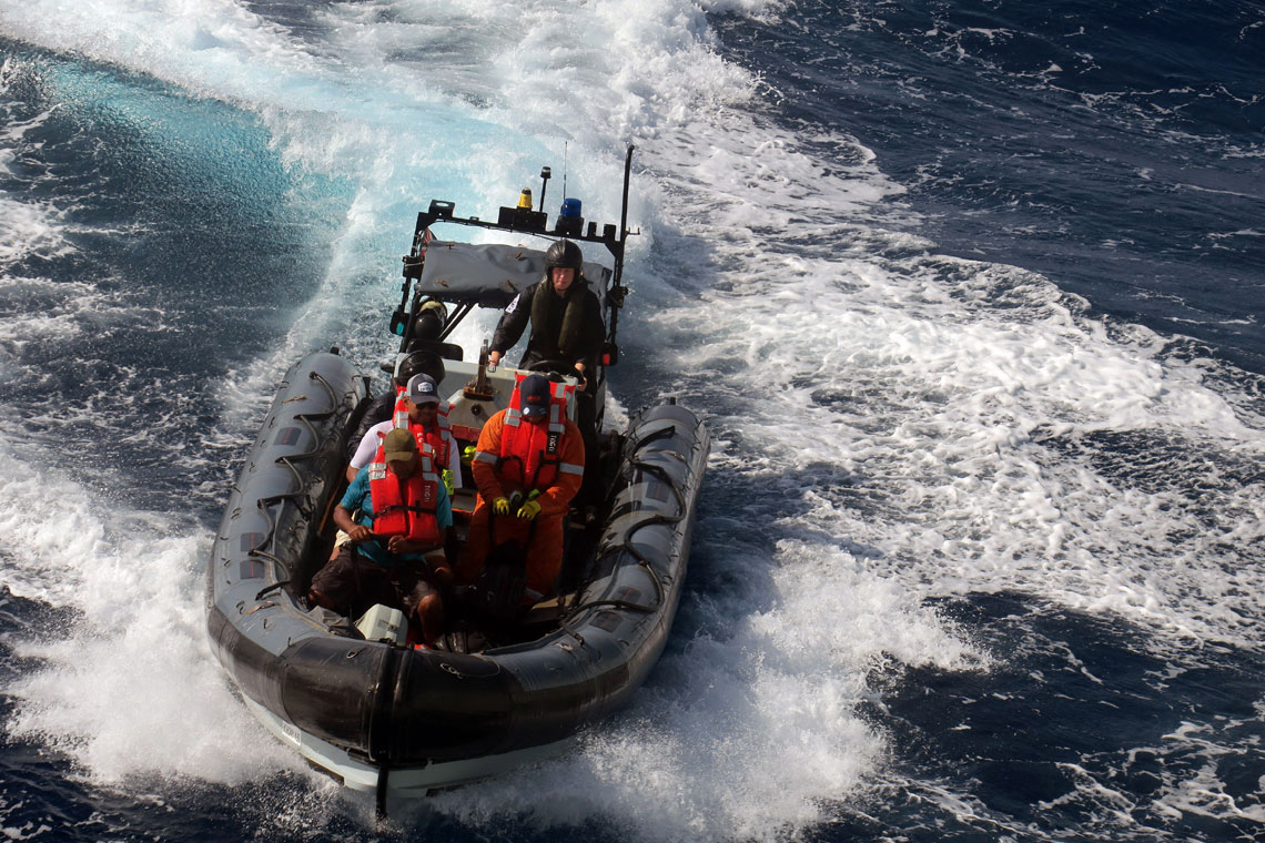 Three of the five rescued tug crew are brought back to HMS Medway