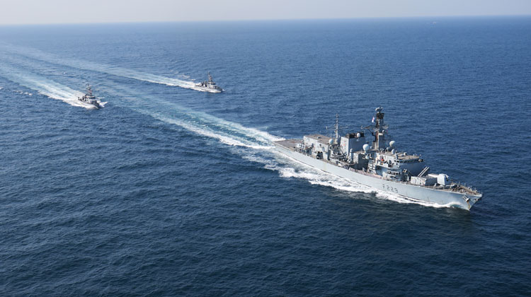 MS Lancaster sails with USS Monsoon and Chinook in the Strait of Hormuz