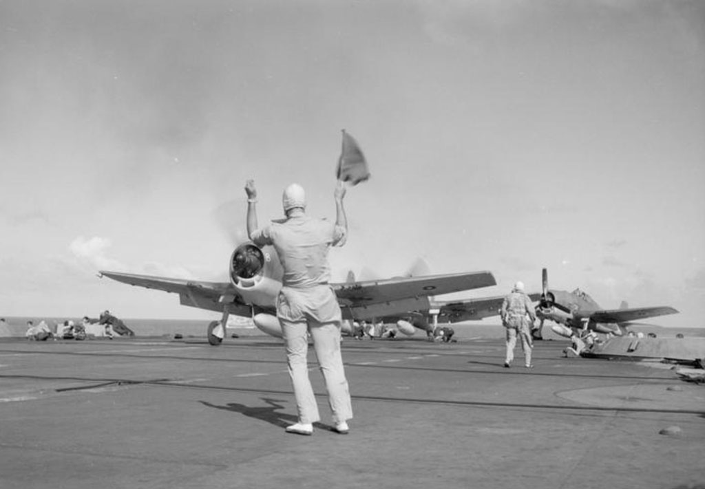 Lt Cdr Chapman prepares to launch a Hellcat fighter from HMS Indomitable