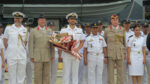 Commander Tom Lindsey receives a traditional welcome from his Cambodian hosts