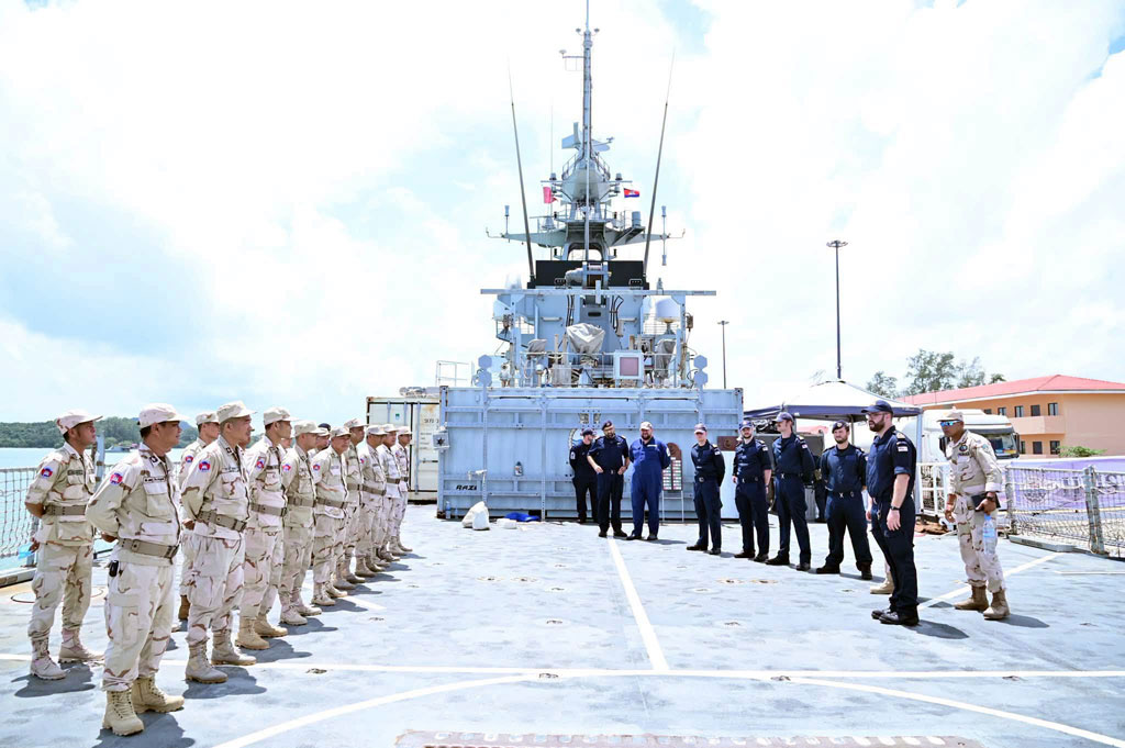 Cambodian military personnel line up on HMS Tamar's flight deck.